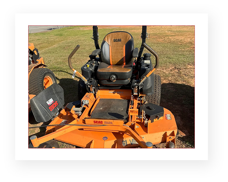 A picture of an orange and black lawn mower.